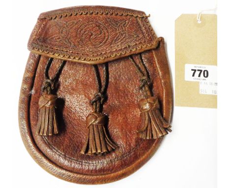 A vintage leather sporran, the flap decorated with Celtic motifs