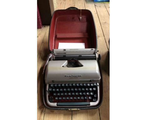 A vintage Remington Quiet-Riter Miracle Tab typewriter in original hard carry case