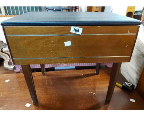 A vintage stained mixed wood sewing box with vinyl upholstered top and fitted interior, set on simple turned legs