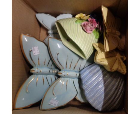 A box containing eight ceramic wall pockets, including butterfly form and SylvaC examples
