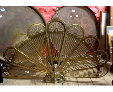 A cast brass peacock form folding firescreen
