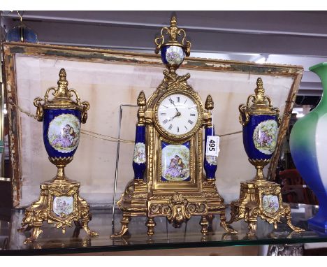 A 3 piece gilt and porcelain clock garniture.