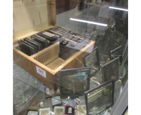 A wooden case of magic lantern slides.