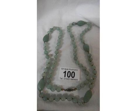 A double knotted jade necklace in good condition.