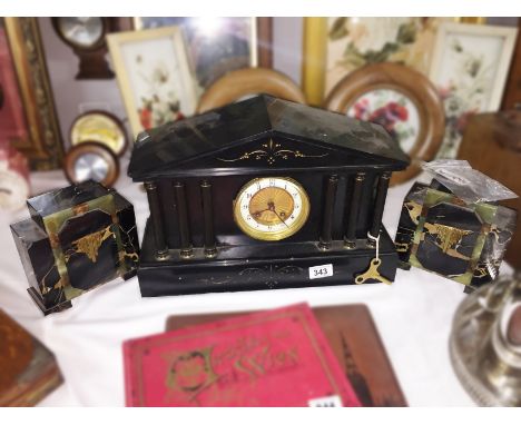A 3 piece black clock garniture.