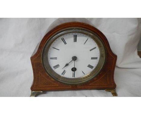 A mahogany inlaid mantel clock in good working order.