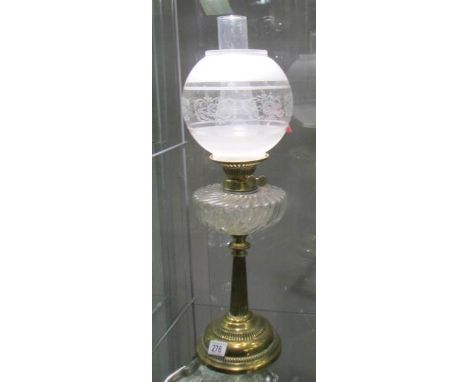 A brass oil lamp with glass font and later etched glass shade.
