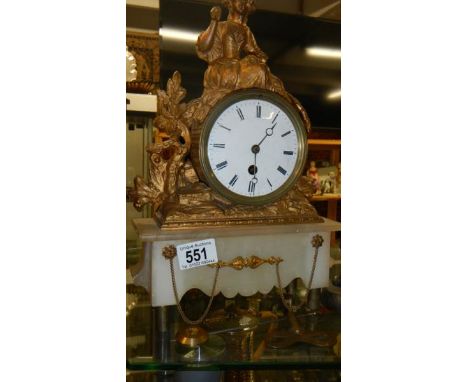 A gilt clock surmounted figure.