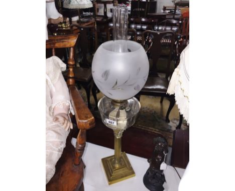 A brass Corinthian column oil lamp with glass font and shade.
