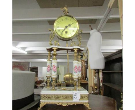 A 4 pillar gilt and porcelain mantel clock.
