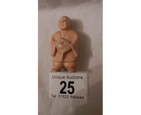 A Victorian ivory netsuke as a figure, signed on foot, in good condition, 2" tall.