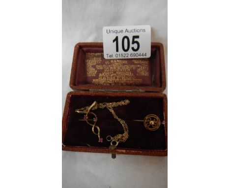 A 9ct gold tie pin and a 9ct gold ruby set pendant.