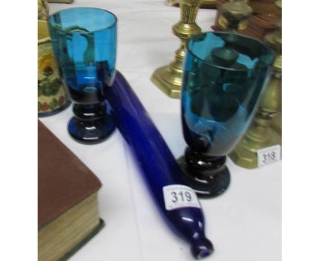 A Bristol blue glass rolling pin and a pair of blue glass vases.