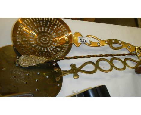 2 brass milk skimmers and a brass toasting fork.