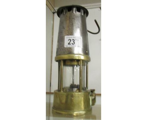 A brass and metal miner's lamp.