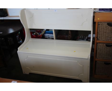 A white painted bench with storage