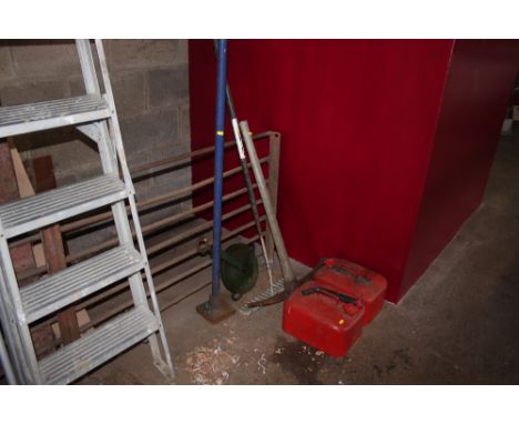 A rake, two petrol cans, a pick axe etc.