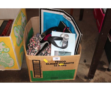A box containing various ornaments, brass candlestick etc. 
