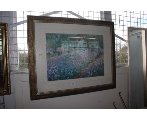 A framed print depicting a woodland scene; together with a gilt framed bevel edged wall mirror
