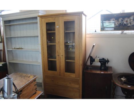 An oak cabinet fitted two drawers