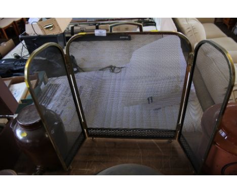 A brass fire screen