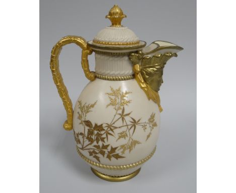 A ROYAL WORCESTER BLUSH LIDDED JUG having a mask head spout, faux bamboo handle and basket weave to foot and neck, decorated 
