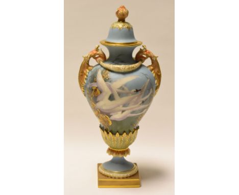 A ROYAL WORCESTER VASE DECORATED BY CHARLES BALDWYN with cover and painted with four swans in flight on powder-blue ground an