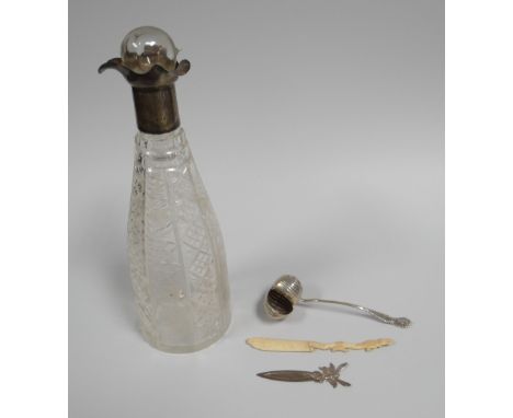 A CUT-GLASS DECANTER WITH SILVER COLLAR, A SILVER SHELL-FORM CASTER SPOON & SILVER BOOKMARK ETC 