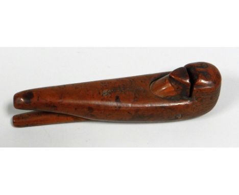 A RARE EARLY FOLK TREEN NUT CRACKER FEATURING A GROTESQUE HEAD being of naïve form when opening and closing on a wooden dowel