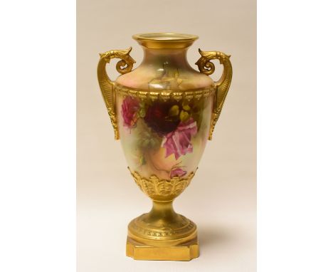 A ROYAL WORCESTER TWIN-HANDLED VASE raised on a chamfered square base and decorated with wild-roses, signed J Llewellyn, 25.5