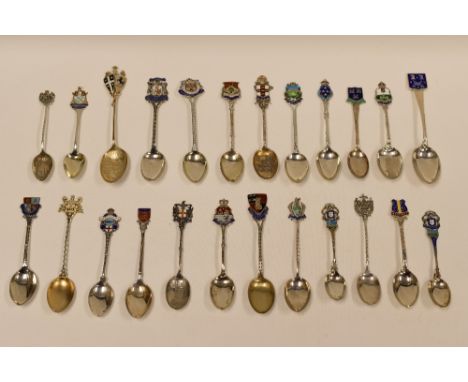 A COLLECTION OF TWENTY-FOUR SILVER SOUVENIR SPOONS for British and Irish resorts, all but three with enamel terminals, 9.9ozs