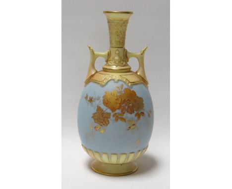 A ROYAL WORCESTER POWDER BLUE TWIN-HANDLED VASE decorated with gilded flowers and with yellow glazed foot and neck, date mark