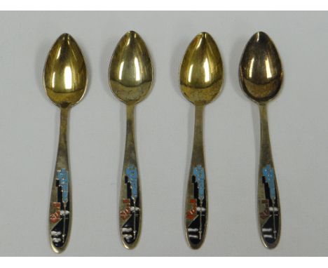 A SET OF FOUR RUSSIAN ART DECO SILVER GILT & ENAMEL TEA SPOONS the terminals enamelled with stylised buildings in four colour