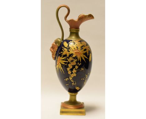 A ROYAL WORCESTER WATER JUG on a square base, with crimped neck and handle terminating in Achelous mask, in cobalt blue groun