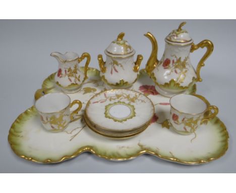 A CHARLES HAVILAND, LIMOGES CABARET SERVICE comprising tray, coffee-pot, cream-jug, lidded sucrier, three cups and two saucer