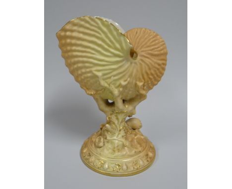 A ROYAL WORCESTER BLUSH SHELL VASE raised upon a circular foot and of naturalist form, dated 1894, 21cms high
