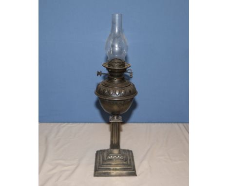 A brass and copper oil lamp, 48cm tall not including glass chimney
