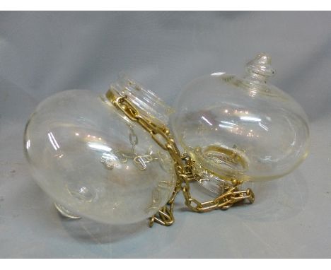 A pair of clear glass 'Globe' ceiling light shades. 