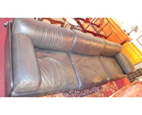 A black leather three seater sofa. 