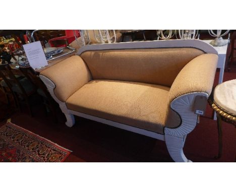 En early 20th Century Regency style two seater sofa with canvas upholstery raised on scroll legs