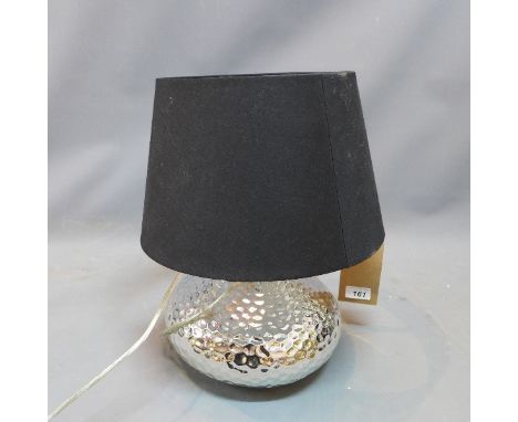 A Contemporary chrome table lamp, of squat form with dimpled decoration, having black shade, H. 44cm