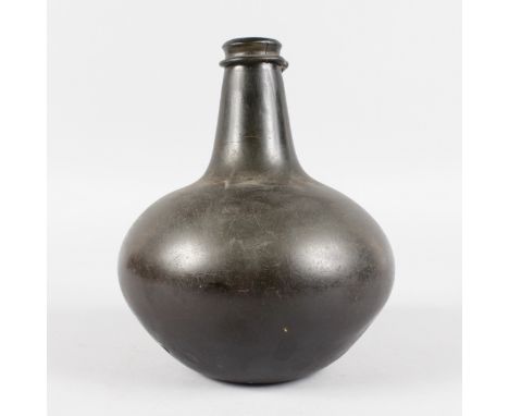 A JAMES II "SACK" ONION SHAPED DARK GREEN BOTTLE. 8.5ins high, 7ins diameter. Excavated in Burma 1933. Please Note: It is bel