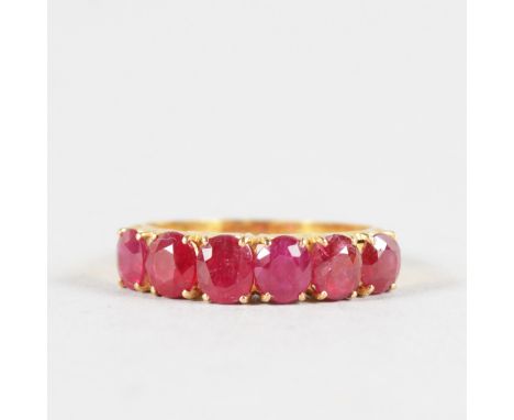 A SIX STONE HALF HOOP RUBY RING set in 22ct yellow gold.