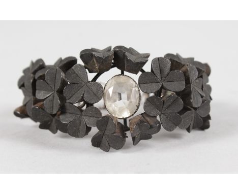 A RARE IRISH BOG OAK CARVED SHAMROCK BANGLE.