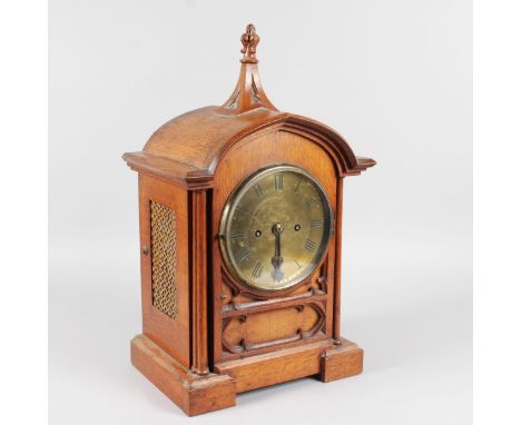 A 19TH CENTURY GOTHIC STYLE OAK BRACKET CLOCK by J. TRUSCOTT, ABERYSTWYTH, with circular brass dial, eight-day movement and s
