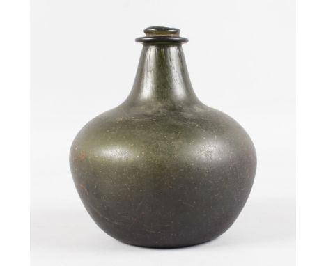 A JAMES II "SACK" ONION SHAPED DARK GREEN BOTTLE. 7.5ins high, 7ins diameter. See label on reverse. Please Note: It is believ