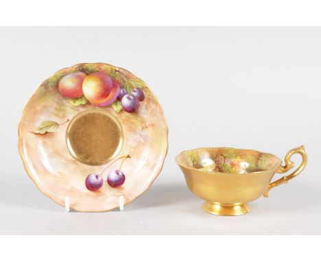 A ROYAL WORCESTER FRUIT PAINTED PEDESTAL TEACUP AND SAUCER, painted with fruit by Townsend, signed date code for 1941.