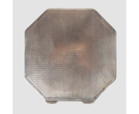 AN ENGINE TURNED SILVER OCTAGONAL COMPACT.
