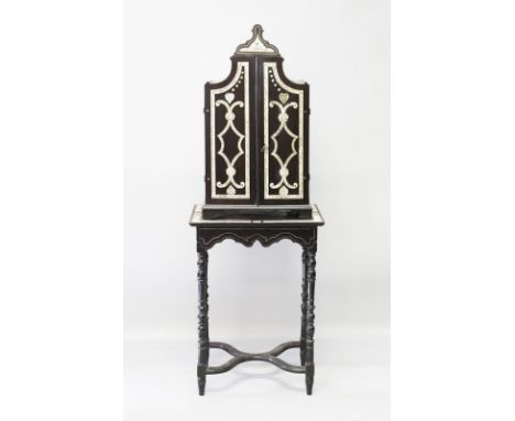 A SUPERB SMALL 18TH CENTURY ITALIAN EBONY AND IVORY CABINET ON STAND, the shaped top cabinet with double doors opening to rev