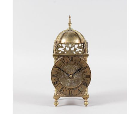 A SMALL BRASS LANTERN CLOCK with French movement. 9.5ins high.